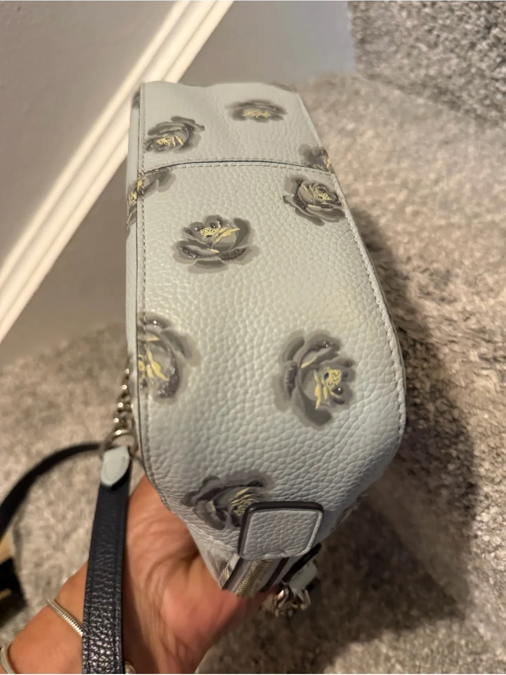 Coach Camera Bag with Rose Print, crafted from polished pebble leather.